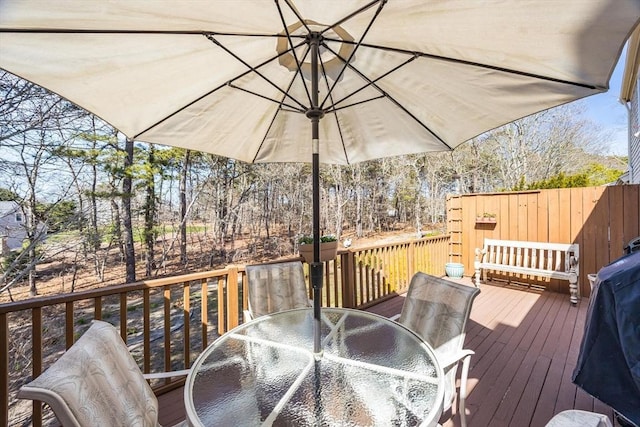 deck with grilling area and outdoor dining space