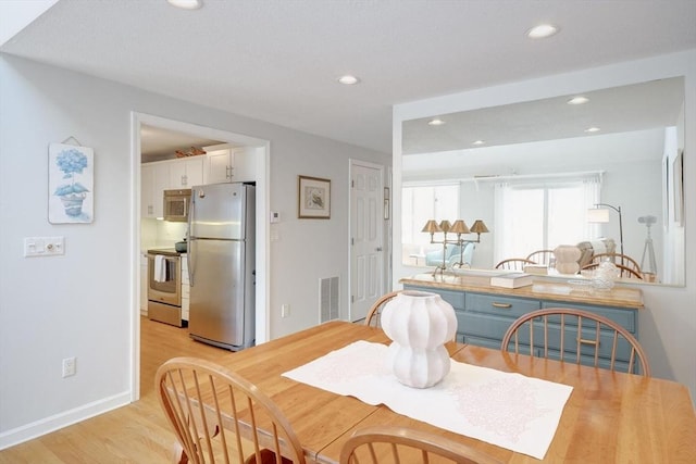 dining area with recessed lighting, baseboards, visible vents, and light wood-style floors