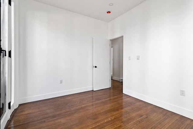 spare room featuring dark wood-type flooring