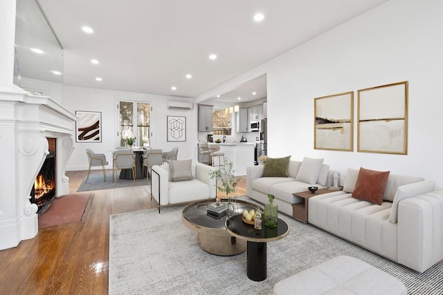 living room with light wood-type flooring and a wall mounted AC