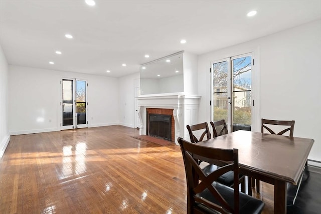 dining space with hardwood / wood-style flooring and baseboard heating