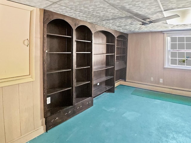 carpeted spare room with wooden walls