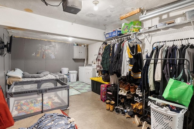 interior space with a textured ceiling and washer and clothes dryer