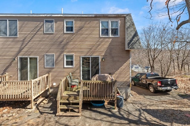 back of property featuring a wooden deck