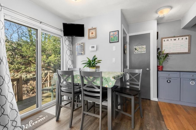 dining area with dark wood-type flooring