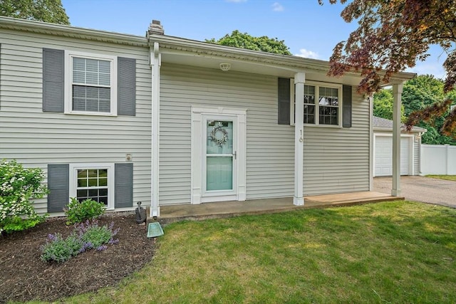 16 Chandler Dr, Marshfield, MA 02050 - back of property featuring a yard, asphalt driveway, and an attached garage