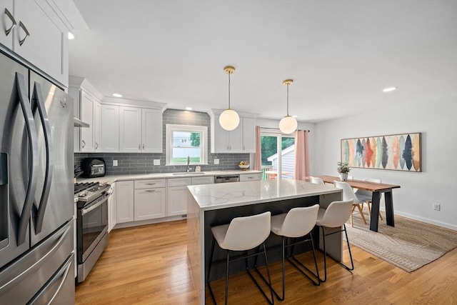 16 Chandler Dr, Marshfield, MA 02050 - kitchen featuring stainless steel appliances, a sink, backsplash, light wood finished floors, and recessed lighting