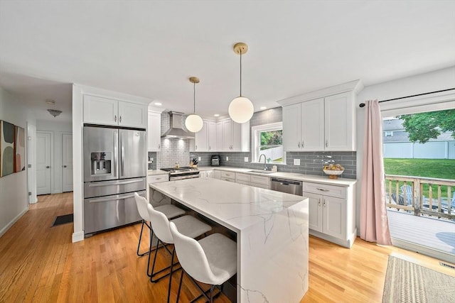 16 Chandler Dr, Marshfield, MA 02050 - kitchen featuring appliances with stainless steel finishes, wall chimney range hood, a sink, a center island, and decorative backsplash