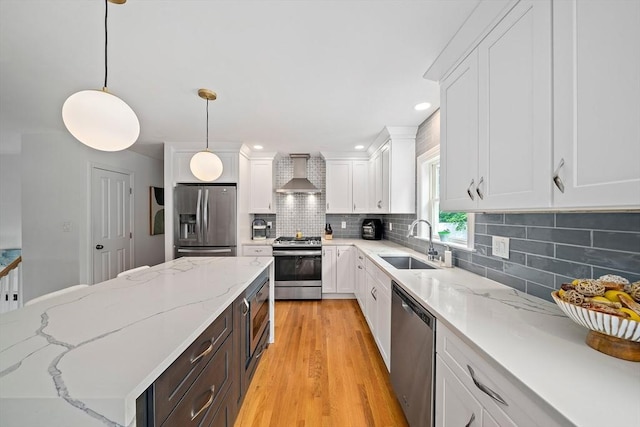 16 Chandler Dr, Marshfield, MA 02050 - kitchen featuring stainless steel appliances, a sink, wall chimney exhaust hood, white cabinets, and decorative backsplash