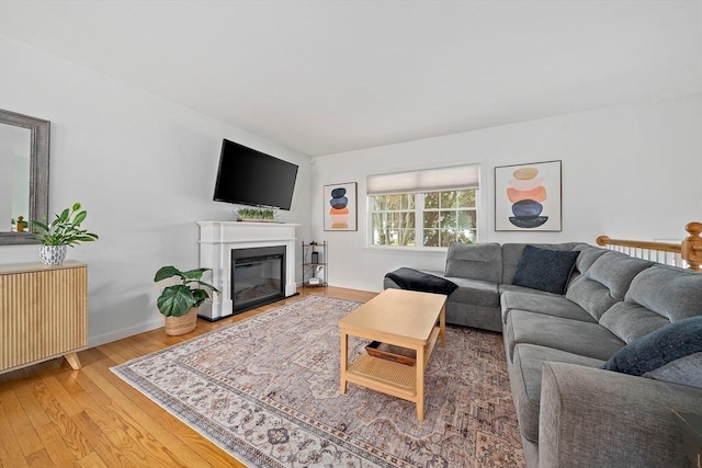 16 Chandler Dr, Marshfield, MA 02050 - living room with wood finished floors, a glass covered fireplace, and baseboards