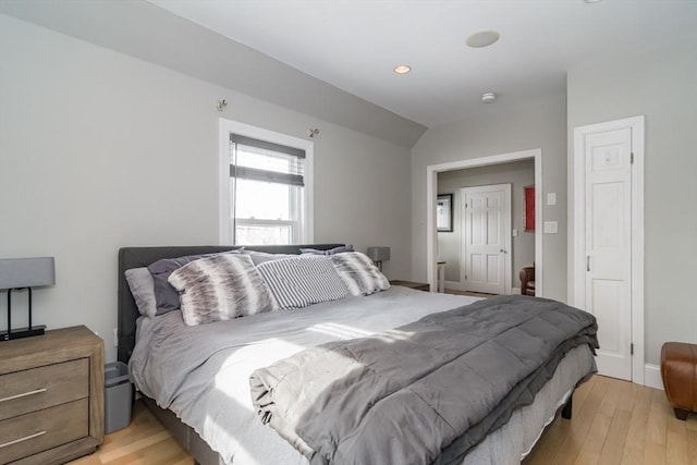 bedroom featuring recessed lighting, vaulted ceiling, and light wood-style floors