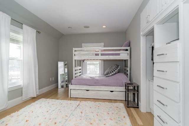 bedroom with recessed lighting, light wood-type flooring, and baseboards