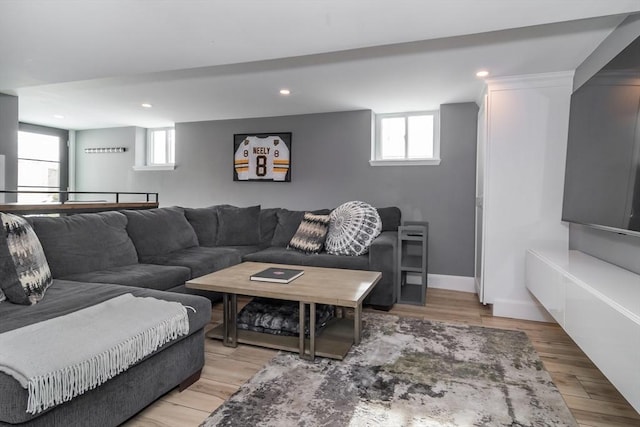 living room with light wood-type flooring, baseboards, and recessed lighting