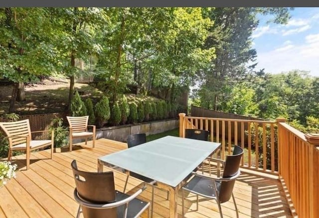wooden terrace with fence and outdoor dining area