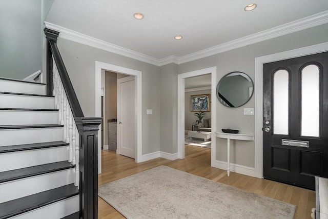 entrance foyer with recessed lighting, stairway, light wood-style flooring, and crown molding