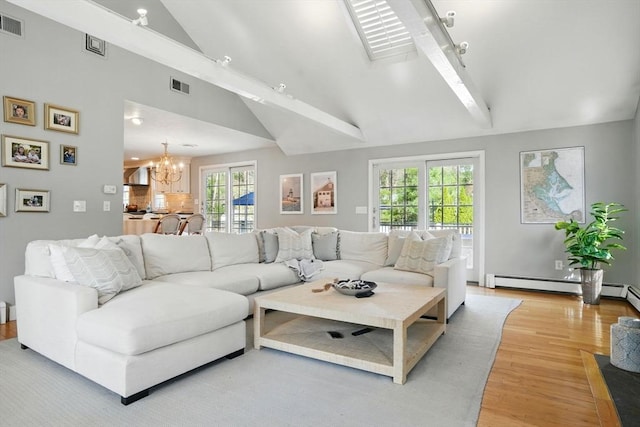 living room featuring visible vents, an inviting chandelier, a healthy amount of sunlight, and light wood-type flooring