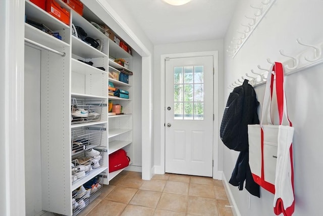mudroom with baseboards and light tile patterned floors