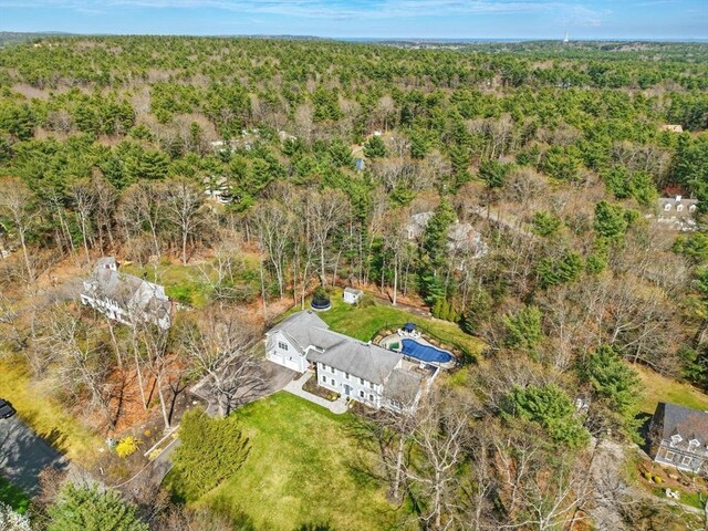 birds eye view of property with a forest view