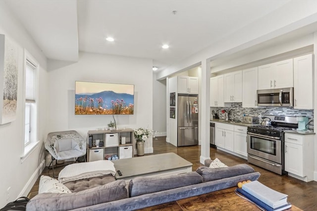 200 W 8th St Unit 1, Boston, MA 02127 - kitchen featuring appliances with stainless steel finishes, decorative backsplash, healthy amount of natural light, white cabinetry, and recessed lighting