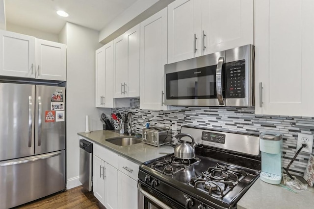 200 W 8th St Unit 1, Boston, MA 02127 - kitchen featuring appliances with stainless steel finishes, a sink, white cabinets, tasteful backsplash, and recessed lighting