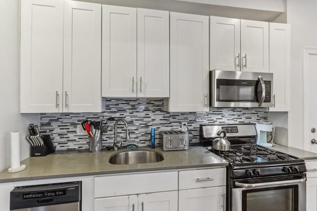 200 W 8th St Unit 1, Boston, MA 02127 - kitchen featuring appliances with stainless steel finishes, a sink, decorative backsplash, and white cabinets
