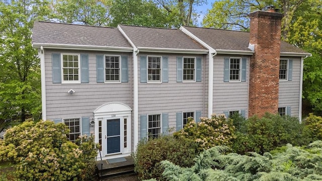 138 Worcester Ln, Waltham, MA 02451 - view of front of home with a chimney and roof with shingles