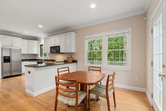 138 Worcester Ln, Waltham, MA 02451 - kitchen featuring stainless steel refrigerator with ice dispenser, black microwave, ornamental molding, a peninsula, and light wood-type flooring
