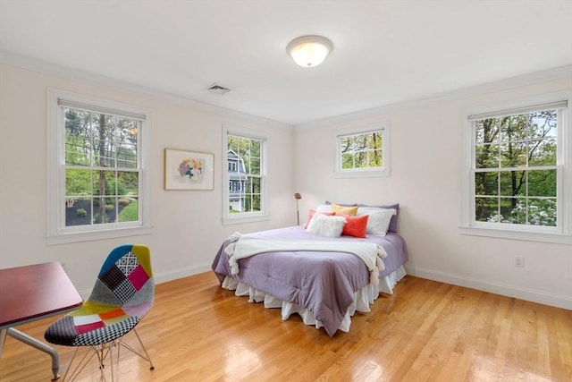 138 Worcester Ln, Waltham, MA 02451 - bedroom featuring ornamental molding, multiple windows, baseboards, and light wood finished floors