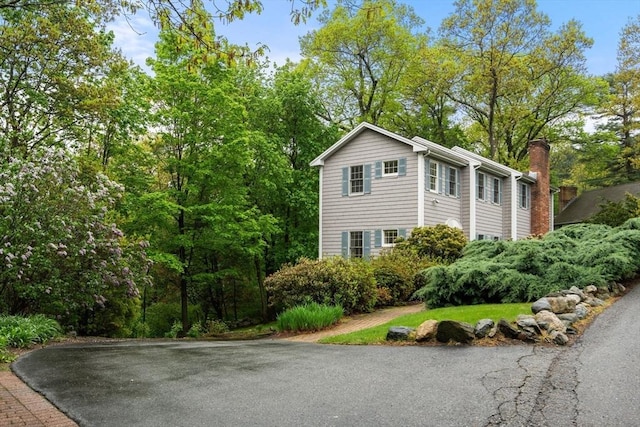 138 Worcester Ln, Waltham, MA 02451 - view of side of home with a chimney