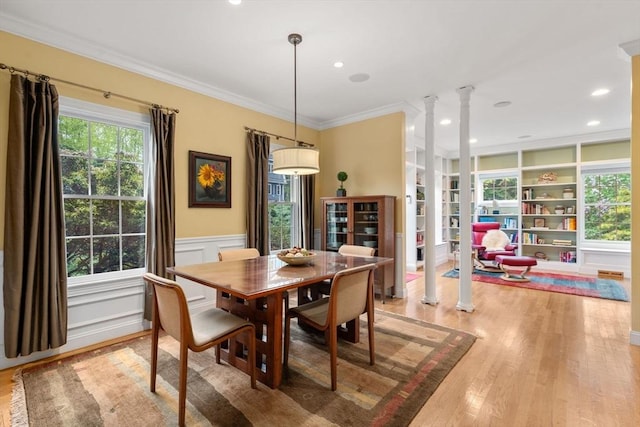138 Worcester Ln, Waltham, MA 02451 - dining area featuring decorative columns, light wood finished floors, ornamental molding, built in features, and a wainscoted wall