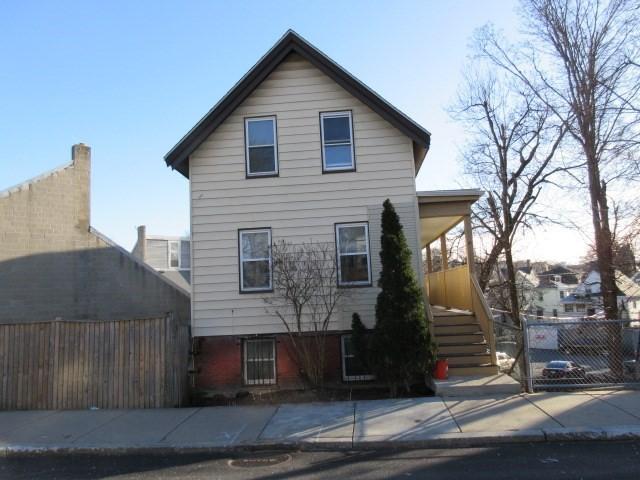 view of front of house with fence, stairway, and covered porch
