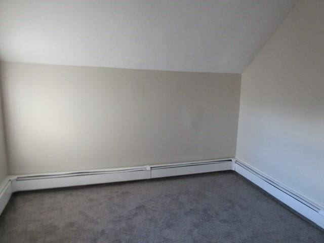 bonus room with carpet, baseboard heating, and lofted ceiling
