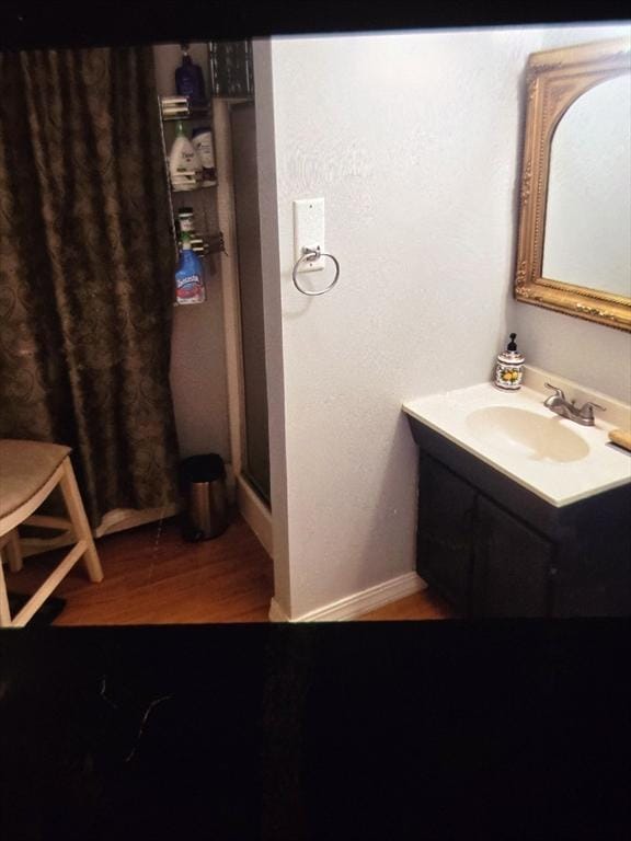 bathroom featuring hardwood / wood-style flooring and vanity