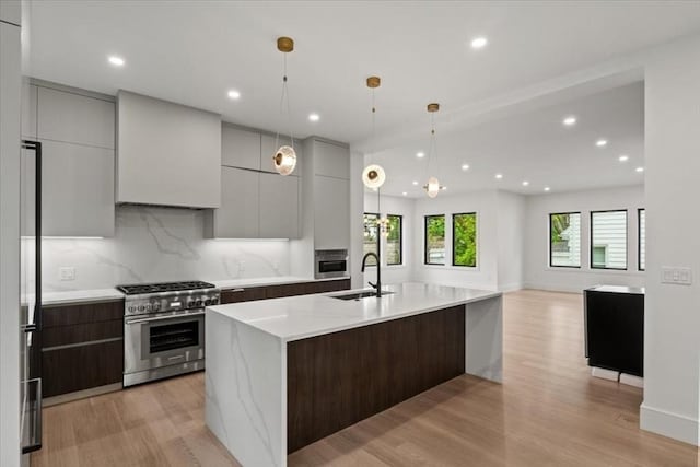 116 Thorndike Rd, Brookline, MA 02446 - kitchen with appliances with stainless steel finishes, modern cabinets, light wood-style flooring, a large island, and recessed lighting