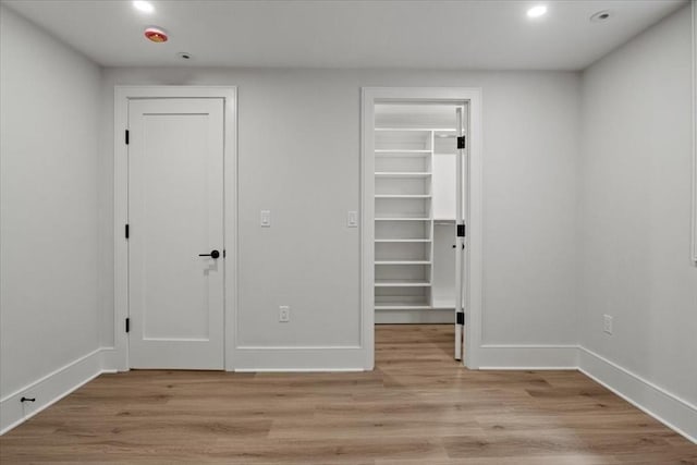 116 Thorndike Rd, Brookline, MA 02446 - unfurnished bedroom featuring recessed lighting, light wood-type flooring, a spacious closet, and a closet