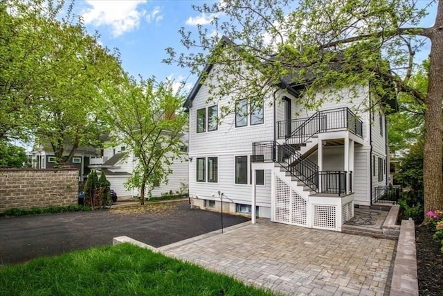 116 Thorndike Rd, Brookline, MA 02446 - rear view of house with stairs and a patio
