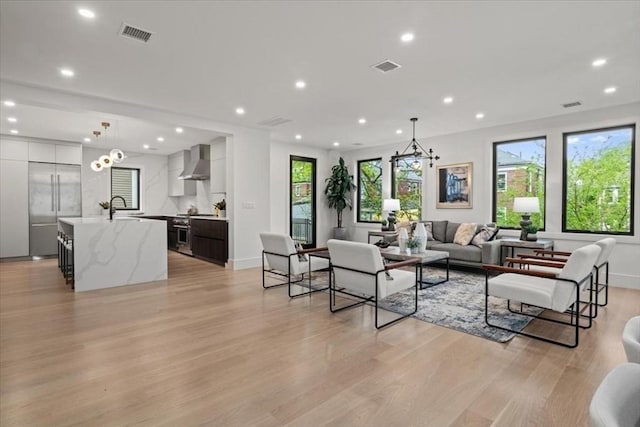 116 Thorndike Rd, Brookline, MA 02446 - living area with recessed lighting, light wood-style flooring, and a chandelier