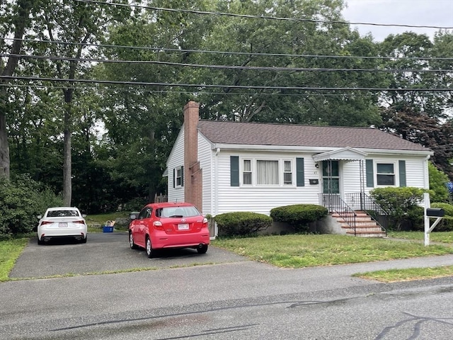 45 Leonard St, Dedham, MA 02026 - view of front of property featuring a chimney, asphalt driveway, and view of scattered trees