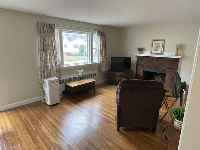 45 Leonard St, Dedham, MA 02026 - living room featuring light wood-style flooring and a brick fireplace