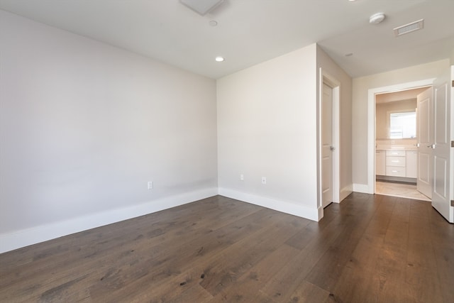 spare room featuring dark hardwood / wood-style floors