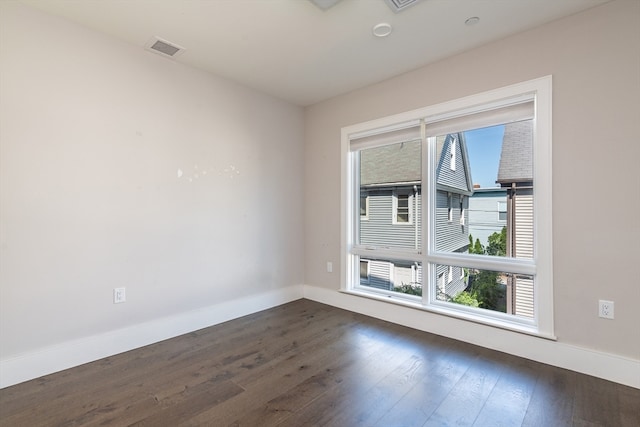 unfurnished room with dark hardwood / wood-style floors