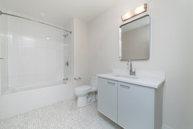 full bathroom featuring tile patterned flooring, tiled shower / bath, toilet, and vanity