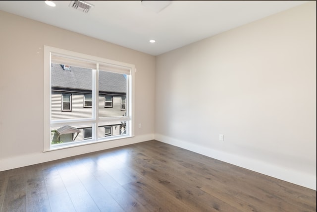 spare room with dark wood-type flooring