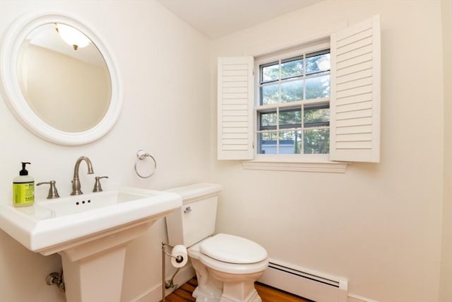 bathroom with a baseboard heating unit and toilet