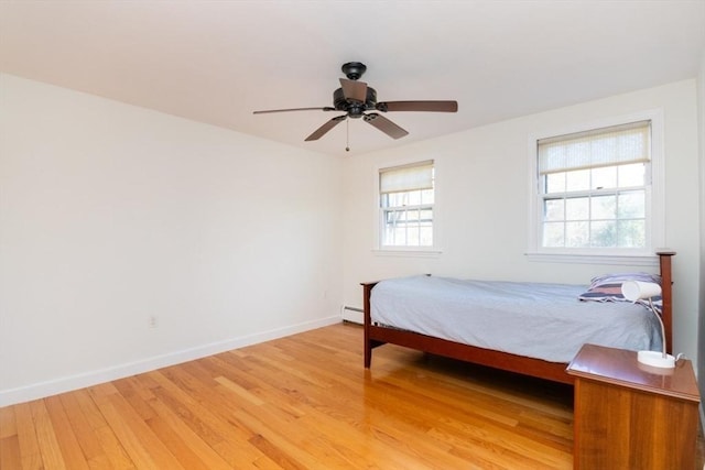 bedroom featuring light wood-type flooring, a ceiling fan, and baseboards