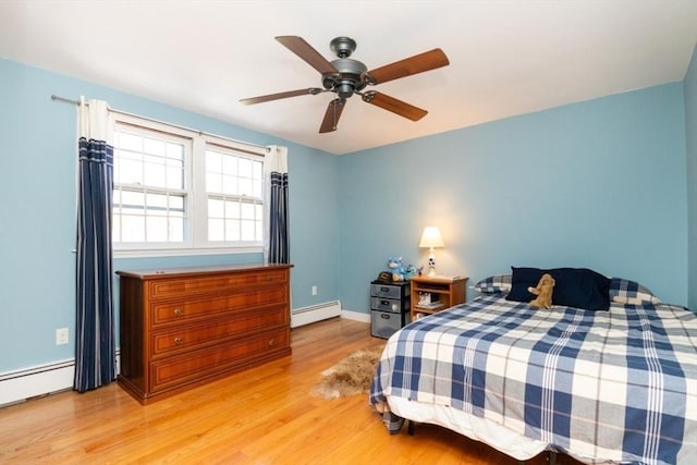 bedroom featuring baseboards, a baseboard radiator, a ceiling fan, and light wood-style flooring