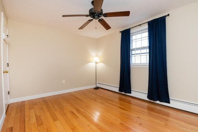 empty room featuring baseboards, a ceiling fan, and light wood-style flooring