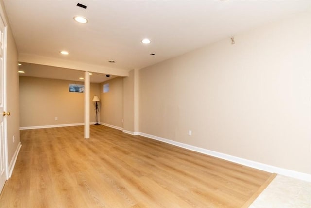 finished below grade area featuring baseboards, light wood-type flooring, and recessed lighting