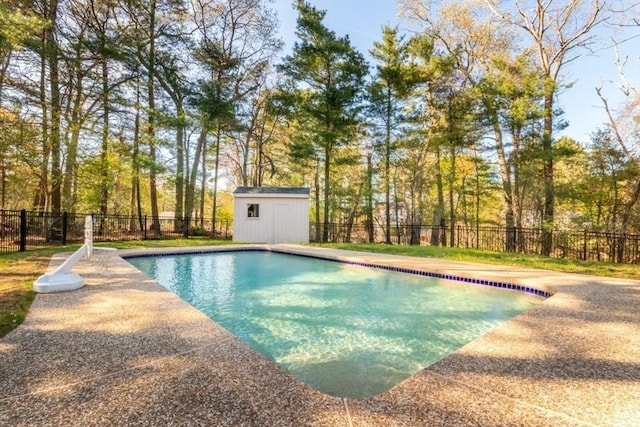 view of pool with a fenced in pool, fence, an outdoor structure, and a storage unit