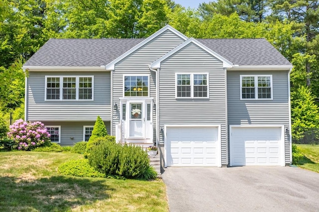 380 Leo Dr, Gardner, MA 01440 - split foyer home featuring driveway, a garage, a front lawn, and a shingled roof